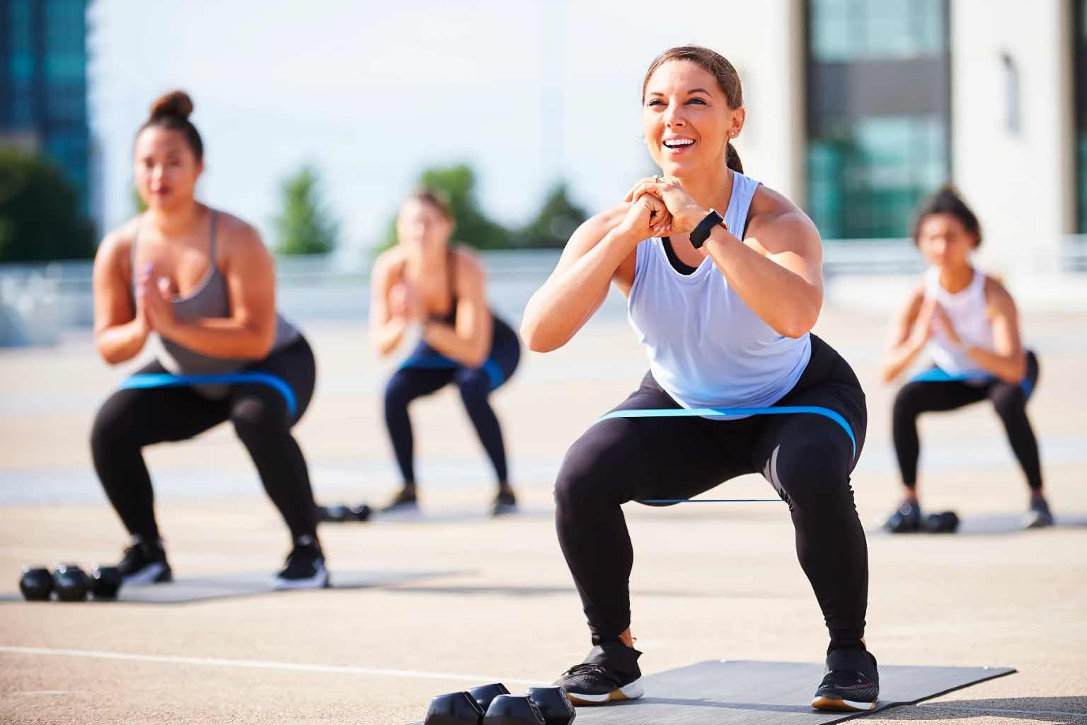 a group of women doing yoga outside