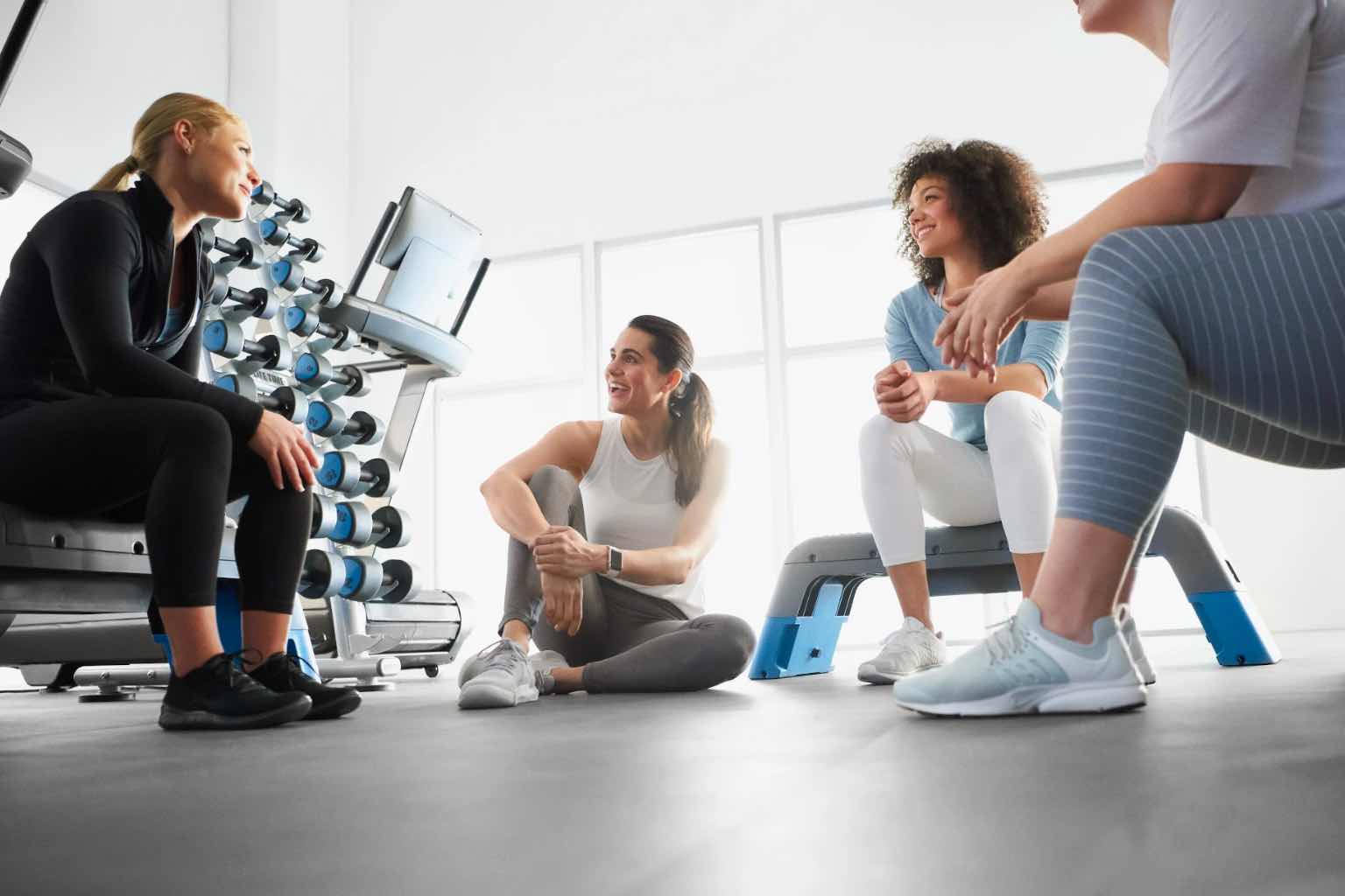 a group of men and women sitting around talking in a class