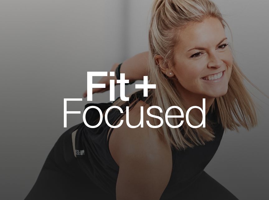 a woman in a black tank top smiling lunging forward