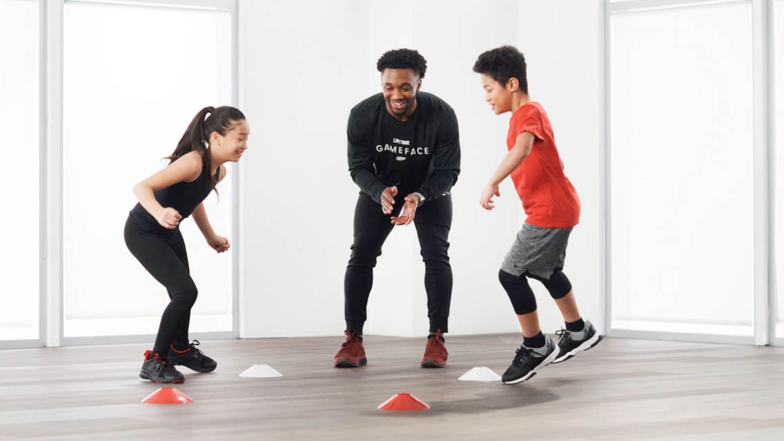 a girl practicing lunges, boy practicing squats, child practicing hurdles