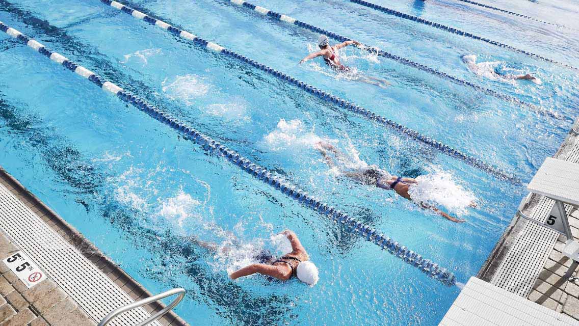 Kids swimming laps in a pool
