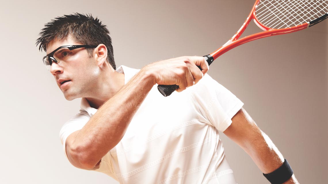 A man after swinging his squash racquet