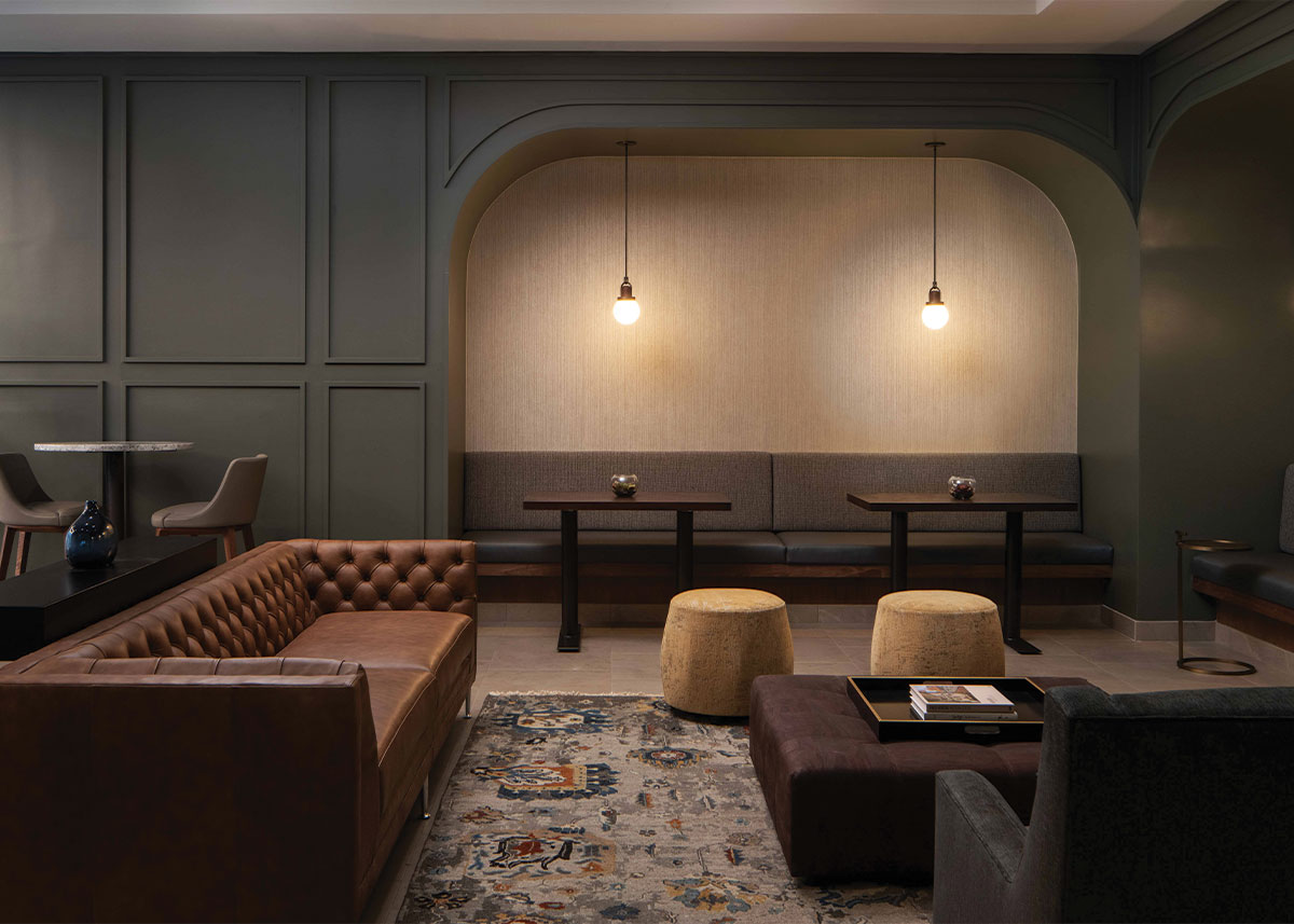 a dimly lit life time work space with couches and tables and chairs