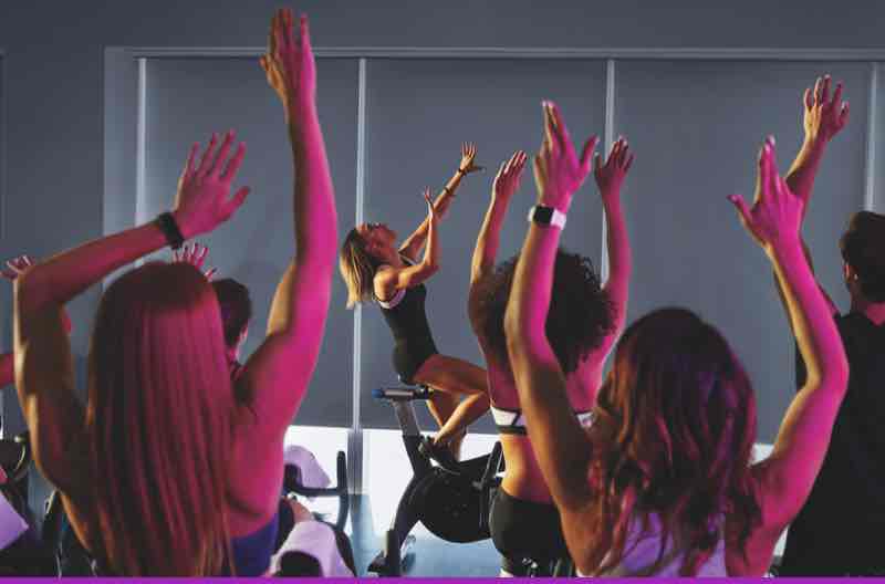 Woman riding a bike in Amp cycle class