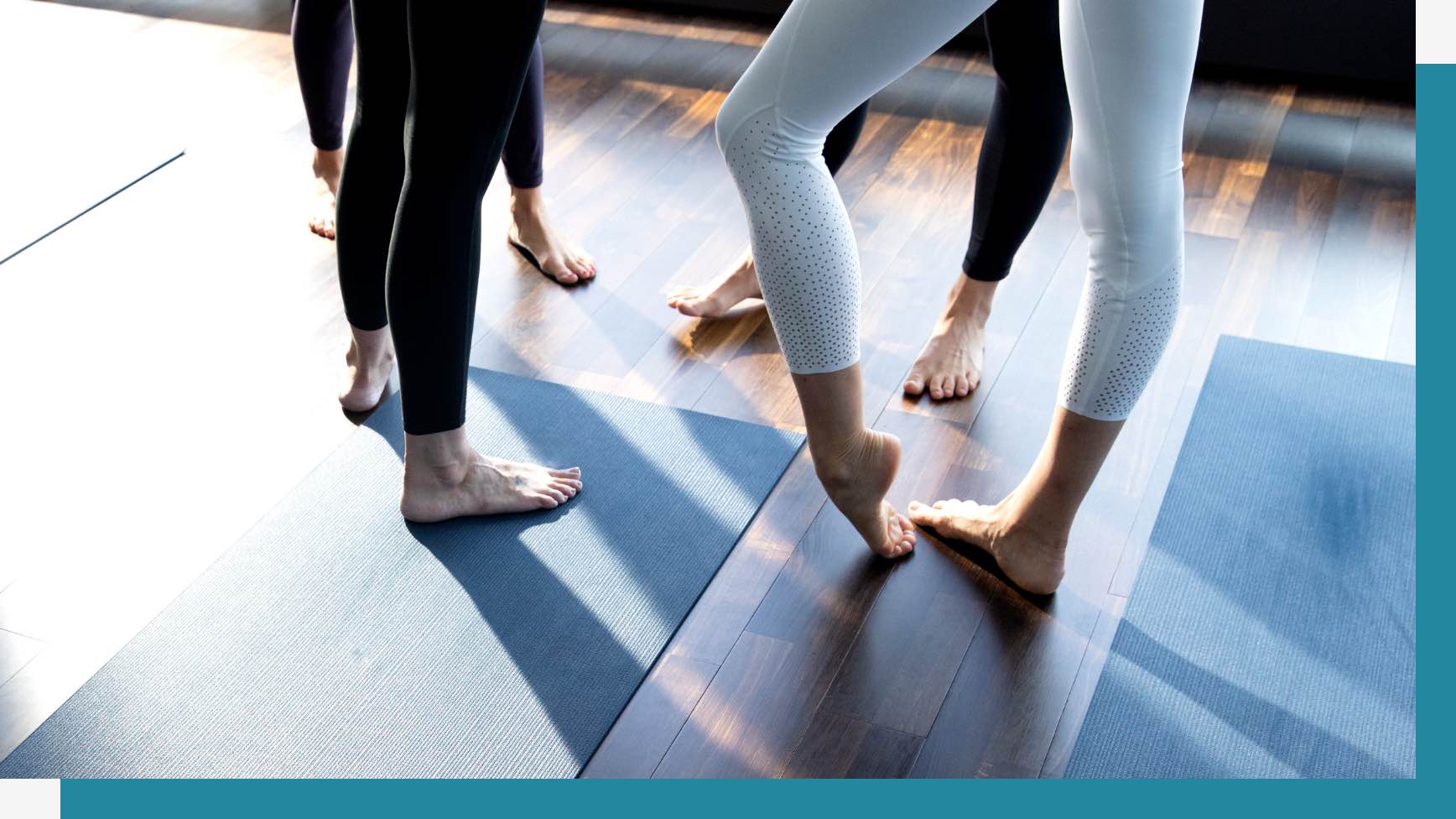 Group of people stretching their feet before class