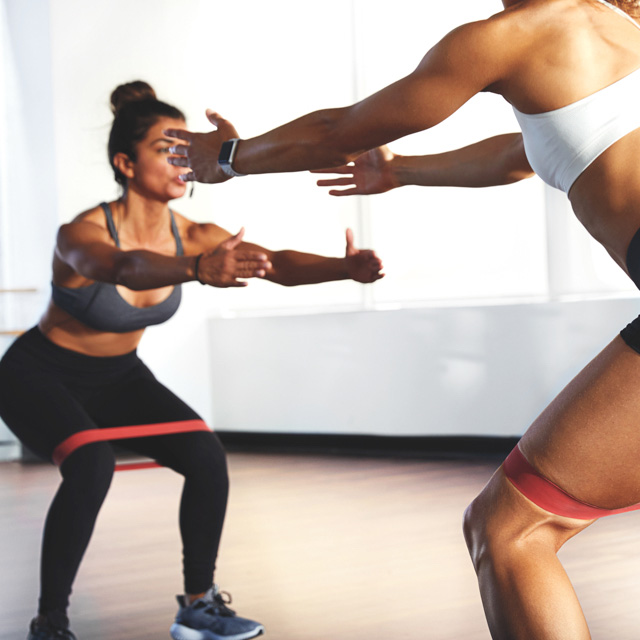 Women doing squats in class