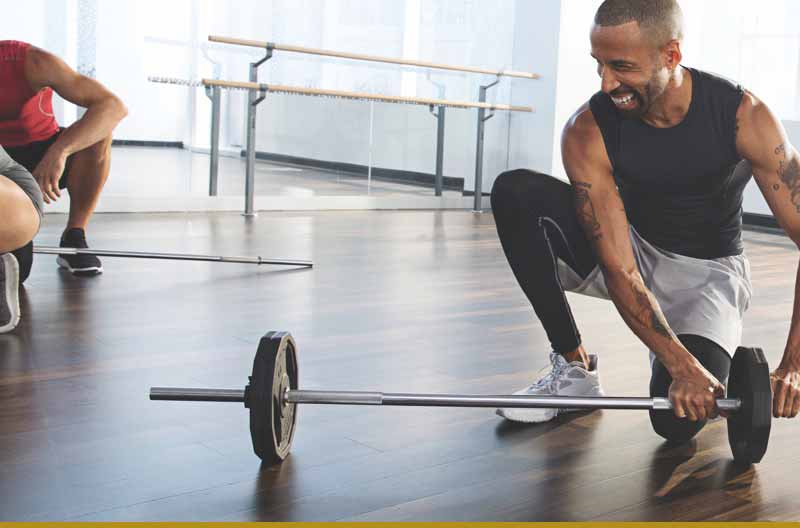 Man putting on weights on a barbell