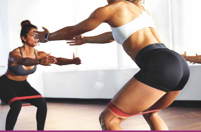 Women doing squats in class