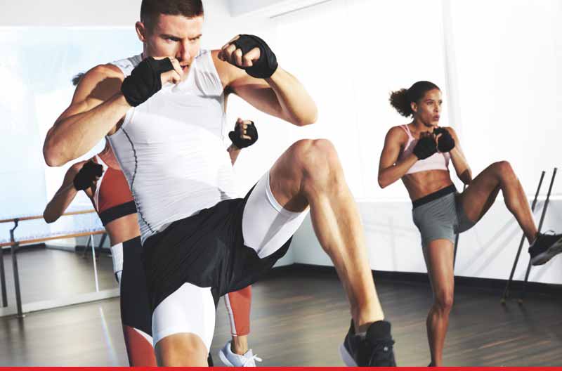 A group of people poised to kick with their left leg